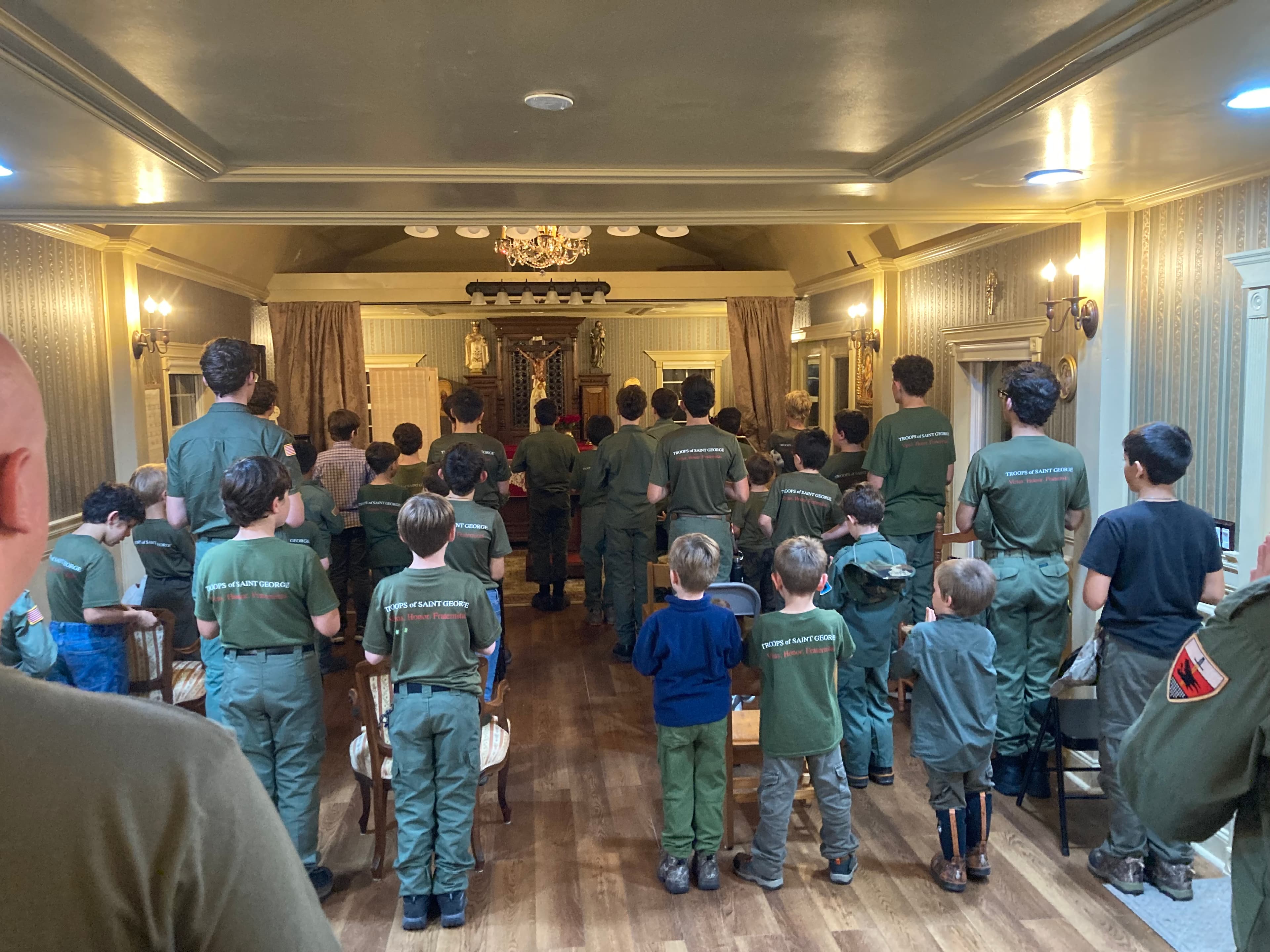 Troop 51 standing for prayer indoors