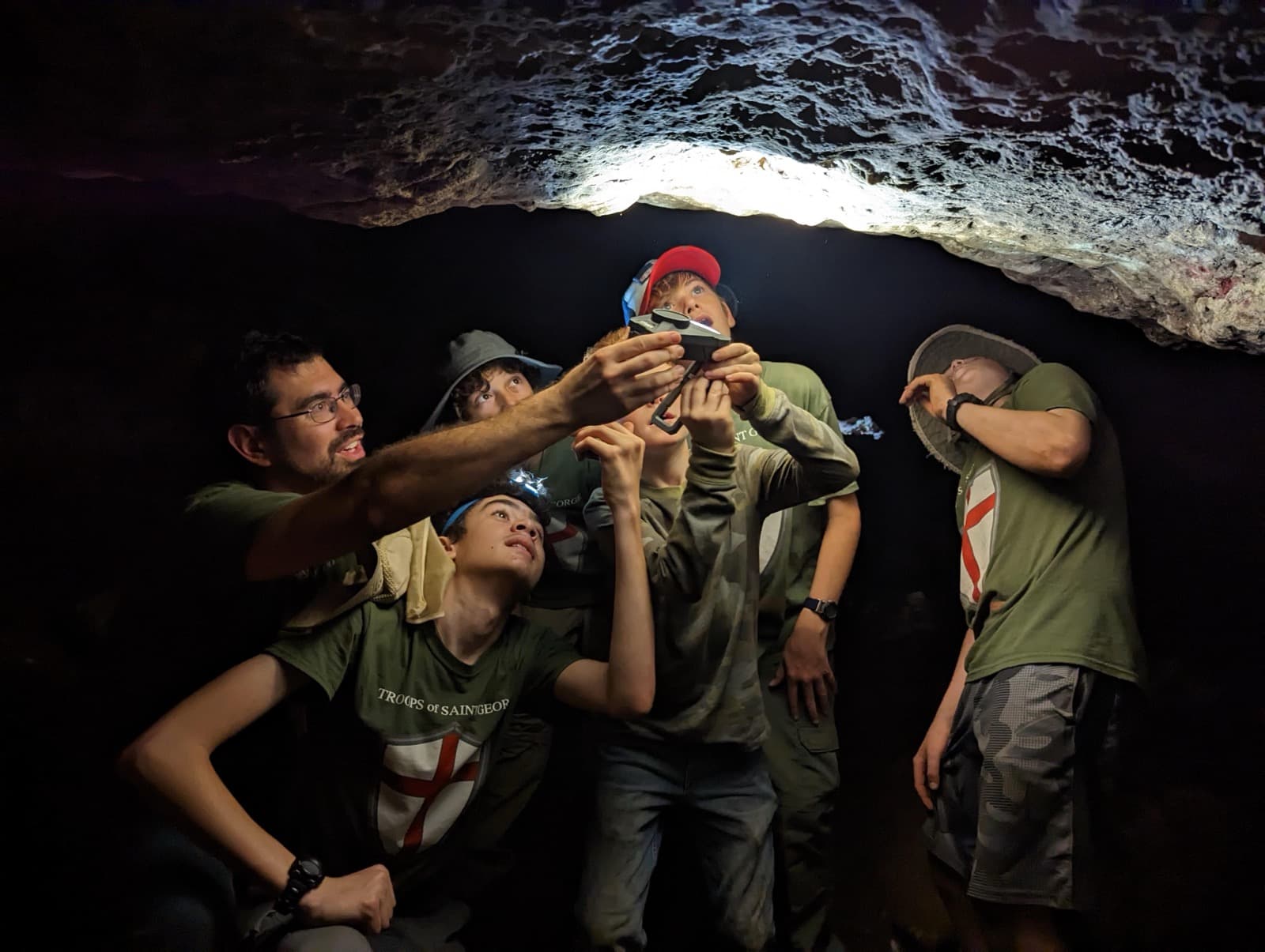 Troop 51 boys exploring a cave with headlamps