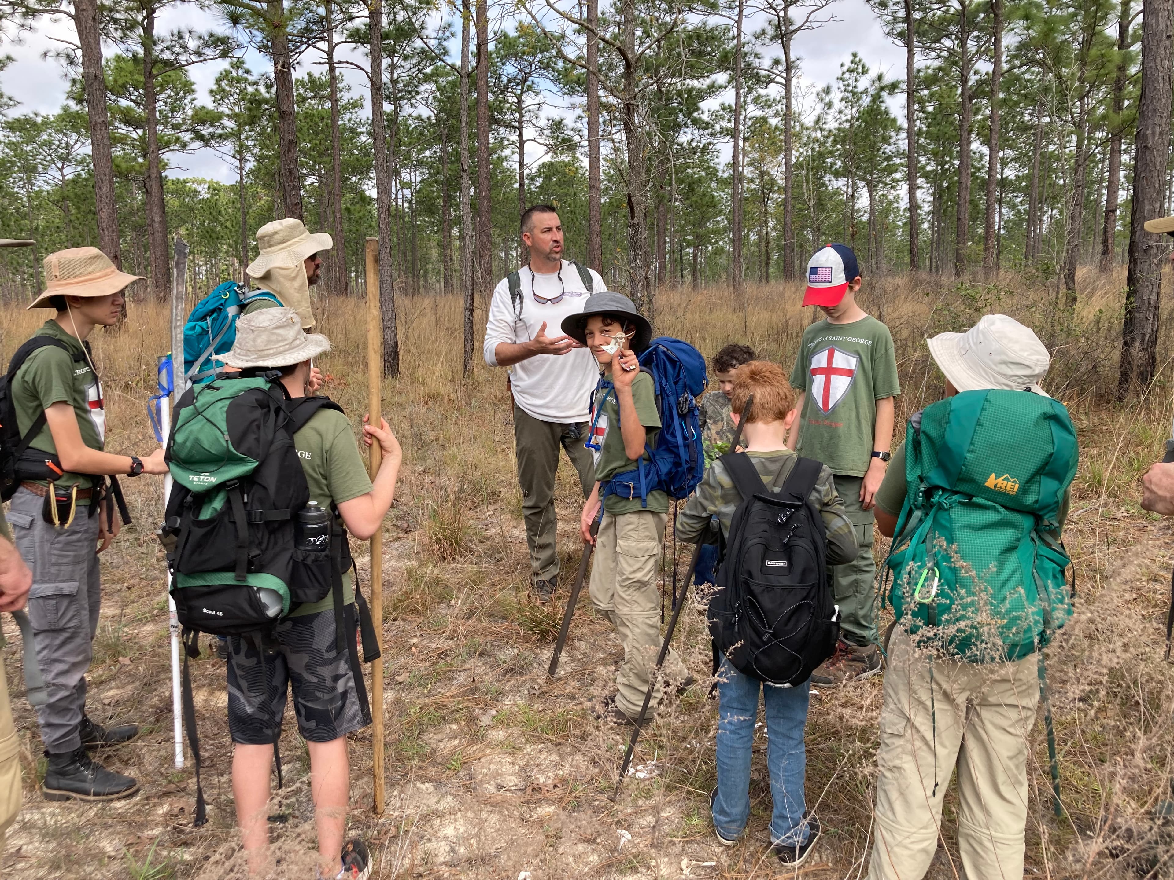 Troop 51 hiking and receiving instruction outdoors